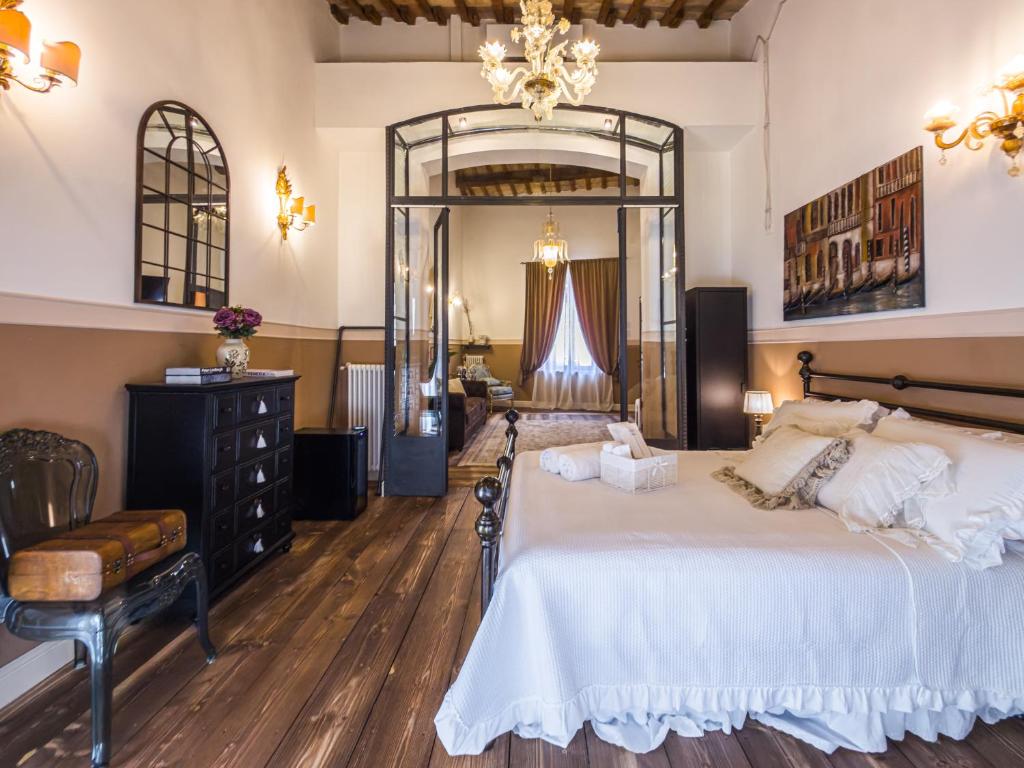 a bedroom with a large bed and a mirror at Palazzo Ravenna in Ravenna
