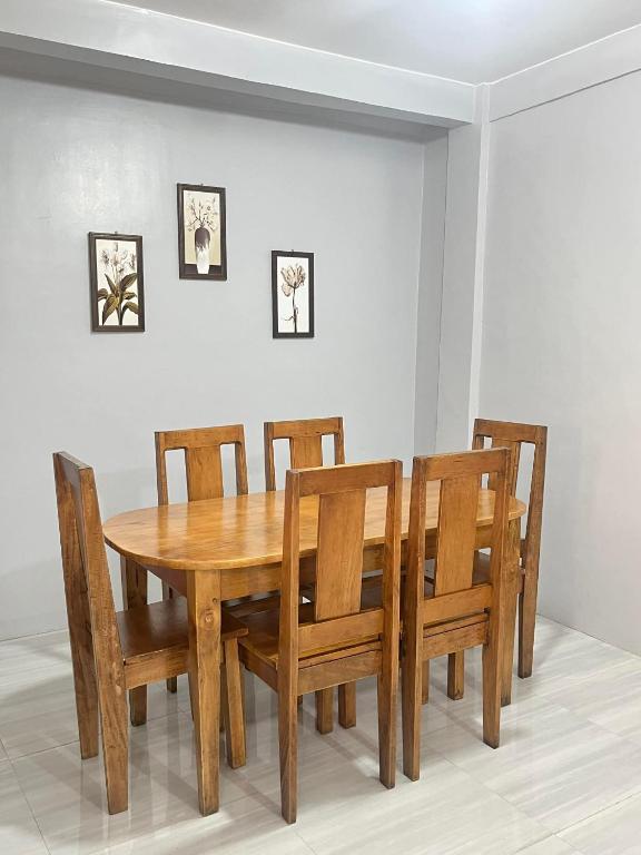 a wooden dining room table with chairs and a table at Nenita in Baybay