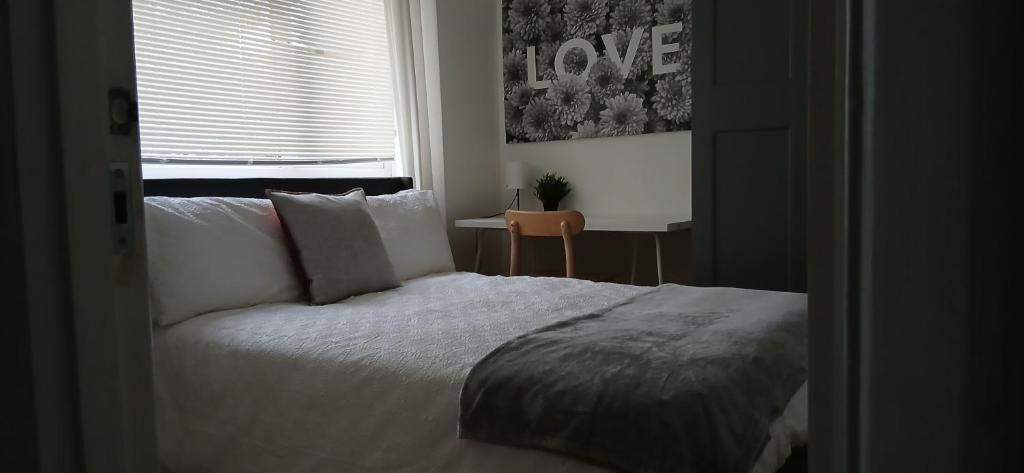 a bedroom with a bed and a window at Eltham Gem in Eltham