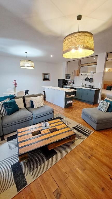 a living room with a couch and a table at La Galupe in Mont-de-Marsan