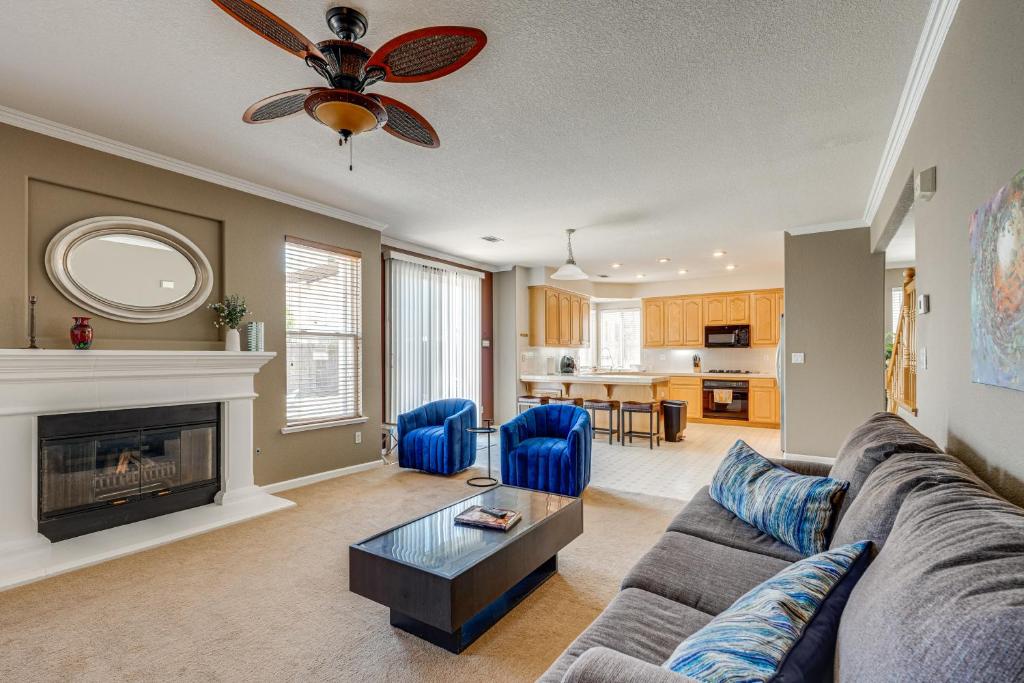 a living room with a couch and a fireplace at Pool Table & Home Gym! Manteca Group Getaway in Manteca
