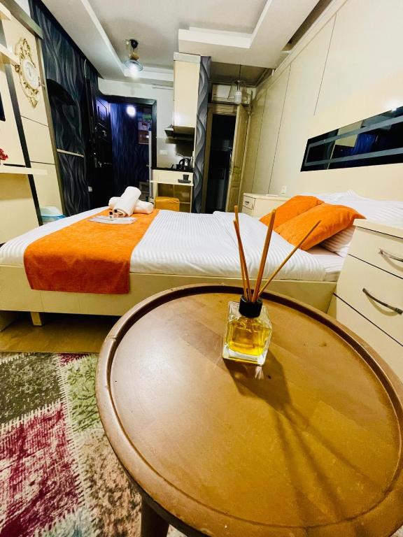 a bedroom with two beds and a wooden table at Taksim Pera Premium Gold Hotel in Istanbul