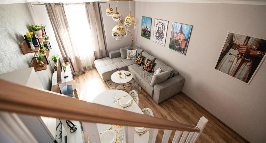 a living room with a couch and a table at The Royal House 102 sqm 2BR Two Floor Apartment in Hunedoara