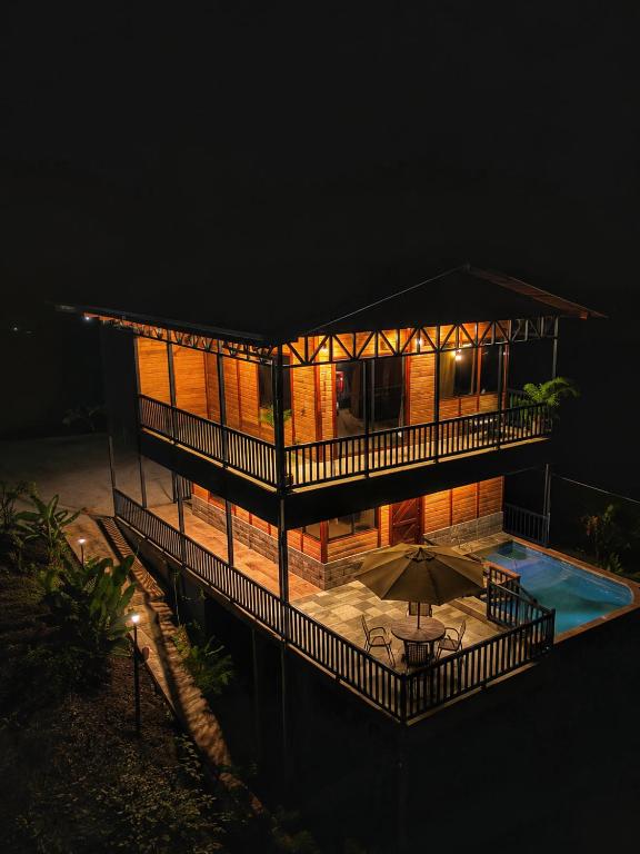 a house at night with a pool in front of it at Cabaña Lancero in San Pedro