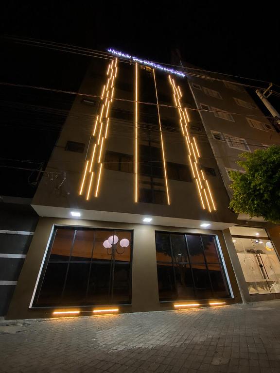 a building with lights on top of it at night at Pousada São Miguel Arcanjo in Aparecida