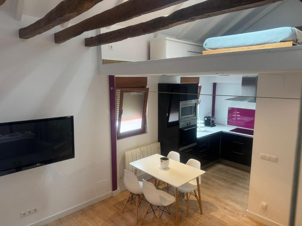 a small dining room with a table and chairs at Loft Adrimar in Santoña
