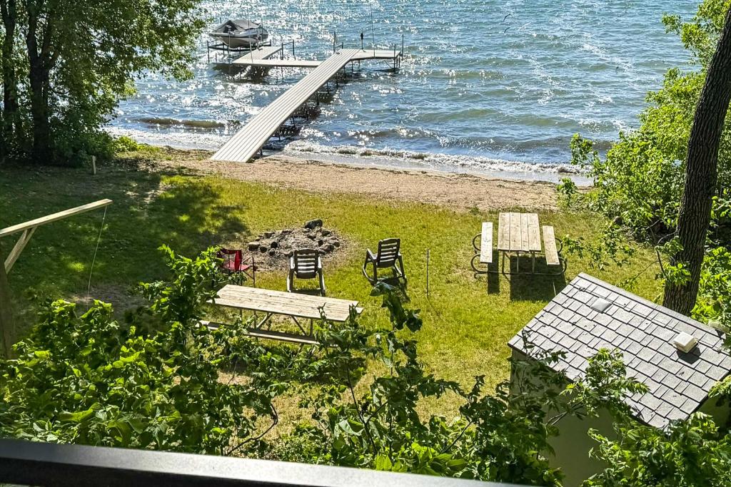 a view of a beach with benches and a dock at Waterfront Leech Lake Cabin: Dock, Fire Pit, Deck in Cass Lake
