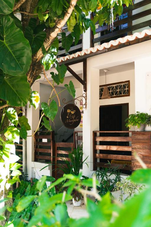 a building with a sign on the front of it at Pousada Munguba in Jericoacoara