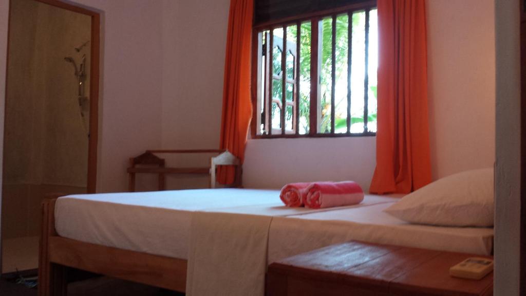 Postel nebo postele na pokoji v ubytování Yaye Guest House