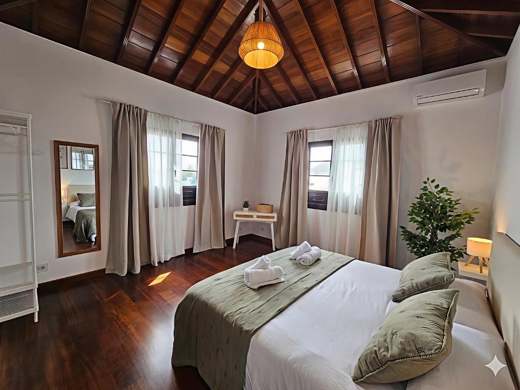 a bedroom with a large bed and a mirror at Casona IROKO in La Costa