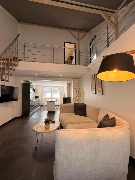 a living room with a couch and a table at Duplex-Cocon-Proximité - frontières in Hombourg-Haut