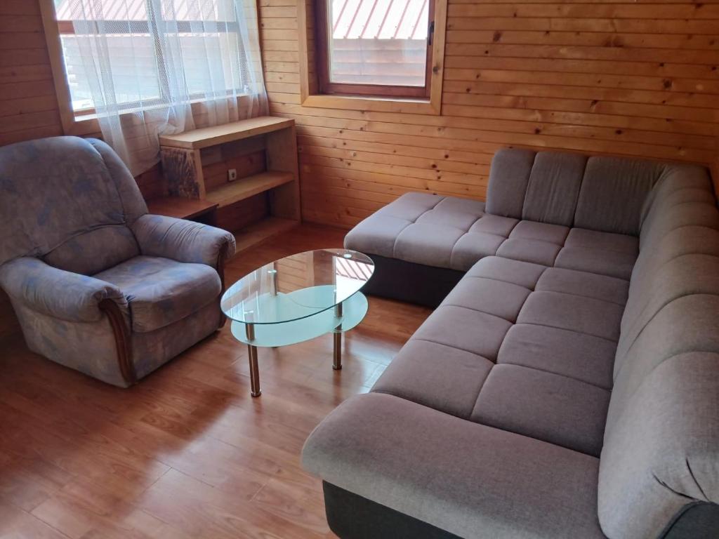 a living room with a couch and a coffee table at Savnik moutain appartement in Šavnik