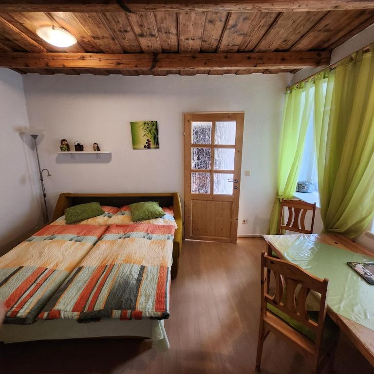 a bedroom with two beds and a window at Ferienhaus Schmidlhof in Oggau