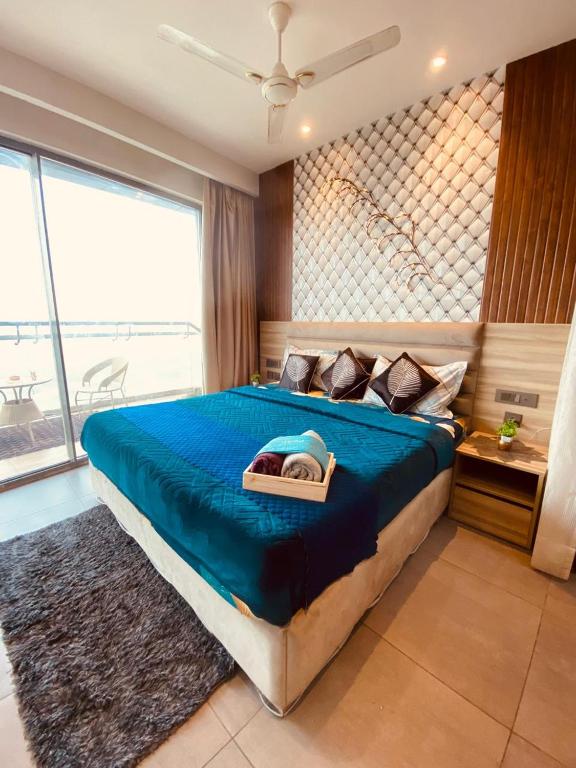 a bedroom with a large bed with a blue blanket at Luxury sup nova in New Delhi