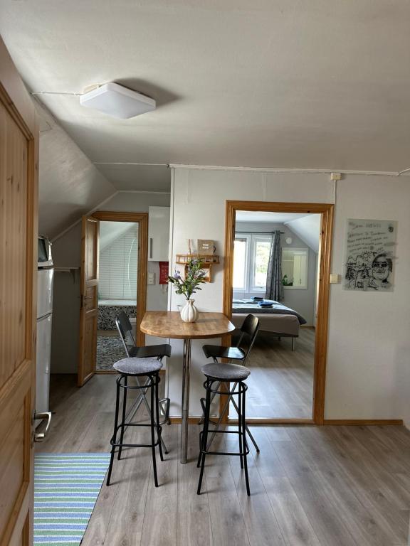 a kitchen and living room with a table and chairs at Loft apartment with 3 bedrooms in Trondheim
