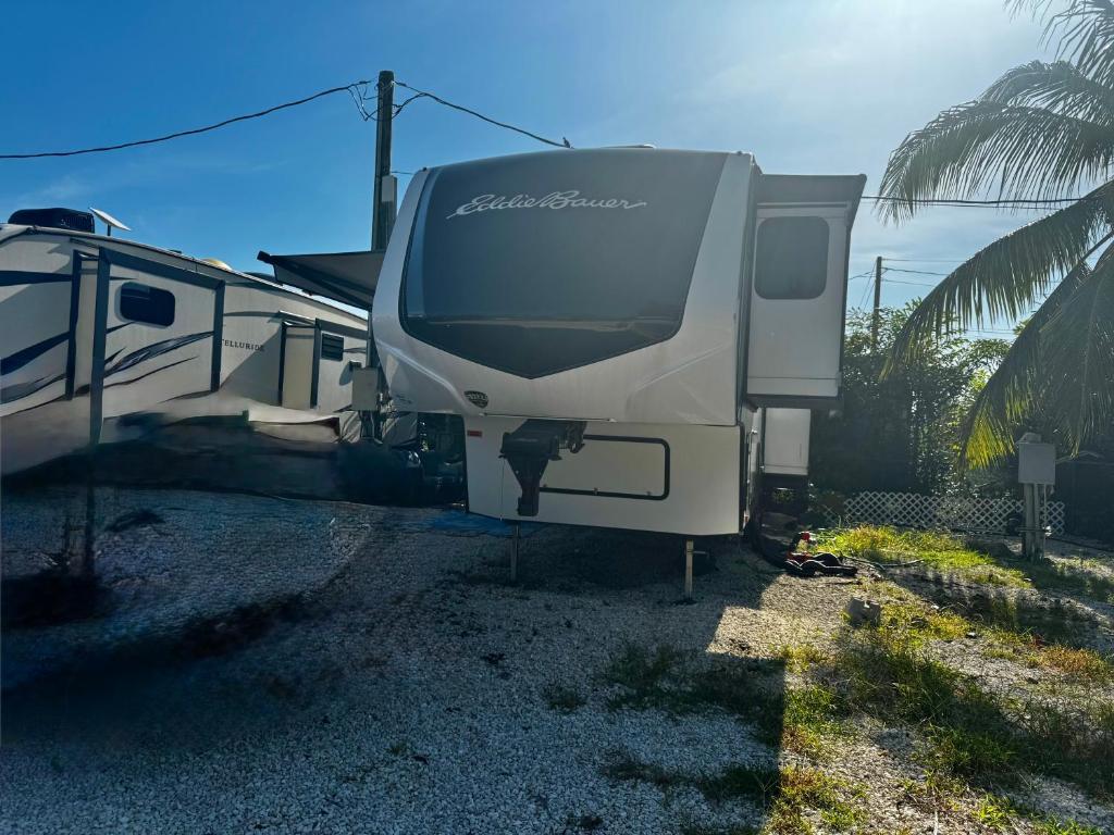 an rv is parked next to a palm tree at EL Camper KW in Key West