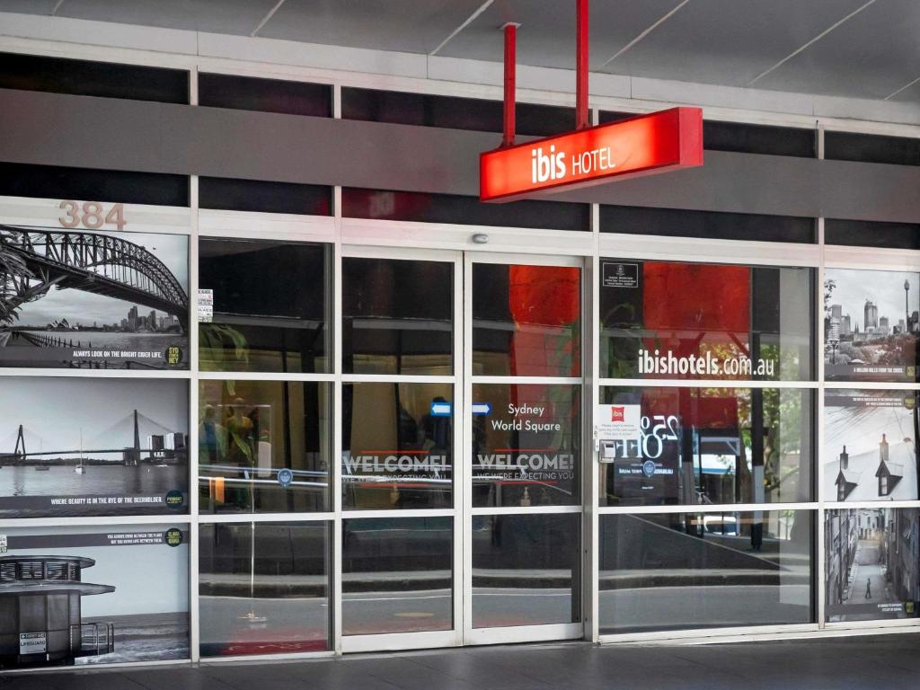 a store front with glass doors and a red sign at ibis Sydney World Square in Sydney