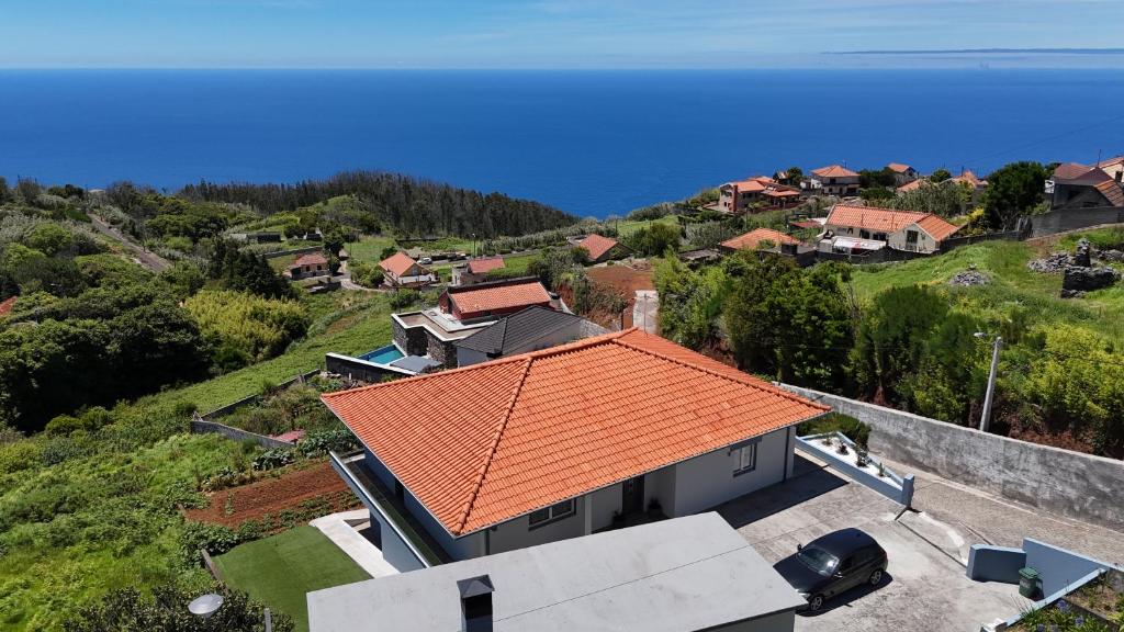 an overhead view of a house with an orange roof at North Pearl Guesthouse in Porto Moniz