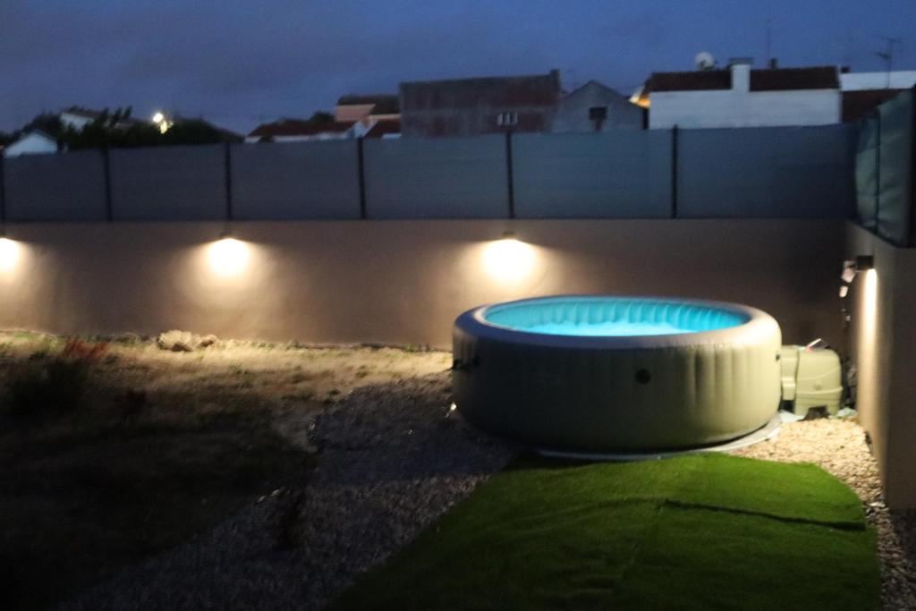a bath tub sitting on the side of a building at night at Curtido House in Aveiro