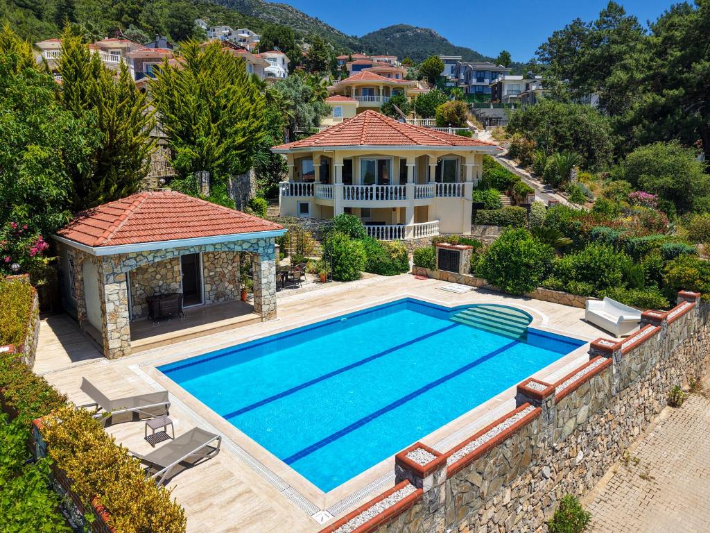 an aerial view of a house with a swimming pool at Private Pool Villa with Garden & Forest View in Fethiye