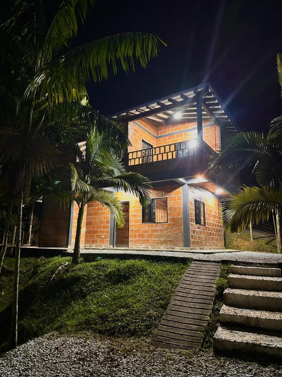 a brick house with palm trees in front of it at chalet Relajante, En San Rafael in San Rafael