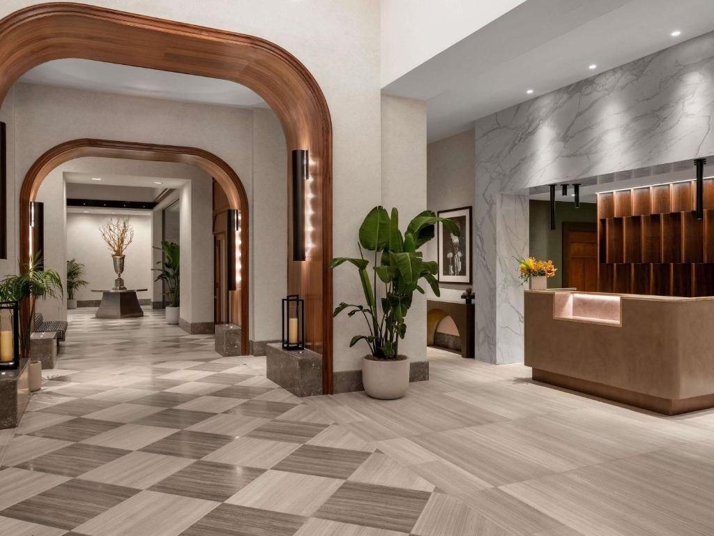 a lobby of a hotel with a hallway with plants at Sofitel Philadelphia at Rittenhouse Square in Philadelphia
