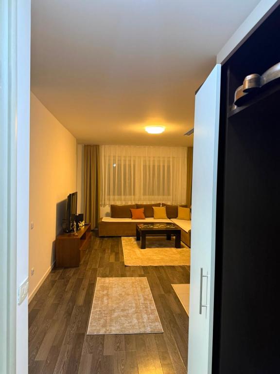 a living room with a couch and a table at City-Center Space in Mitrovica