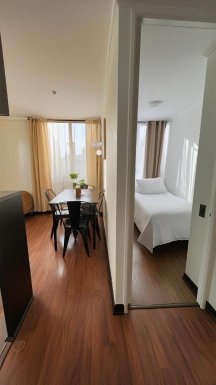 a room with a table and a bed and a bedroom at Apartments Bellas Artes in Santiago