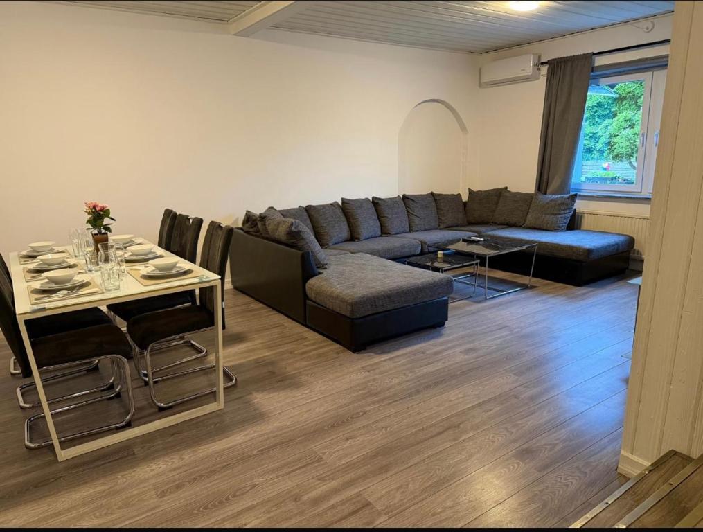 a living room with a couch and a table at Four bedroom house close to the beach in Abbekås