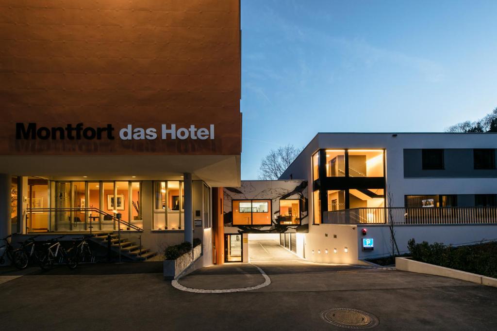 a building with the front of a montford glass hotel at Montfort - das Hotel in Feldkirch
