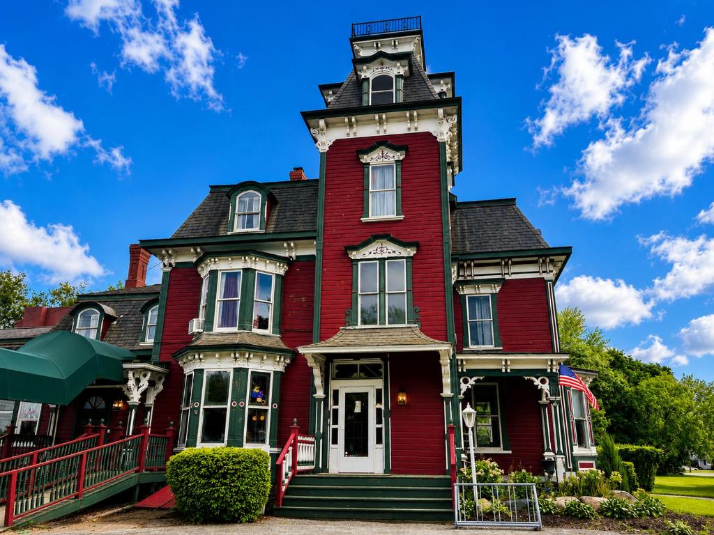 a red house with a clock tower on top at Garfield Inn in Port Austin