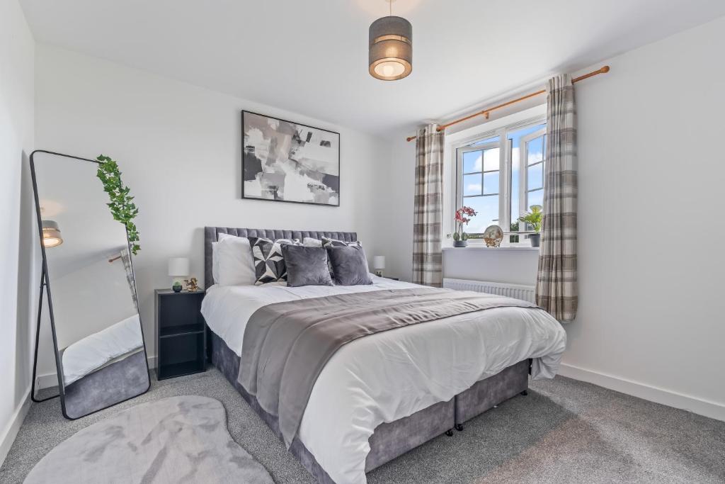a bedroom with a large bed and a window at The Mersey Sanctuary in Liverpool