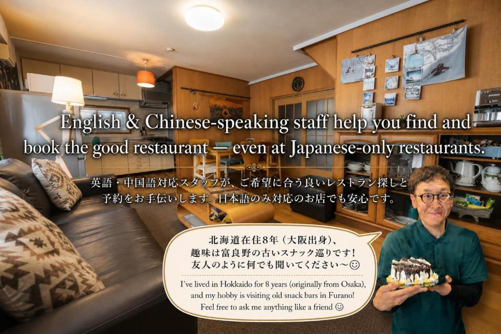 a man holding a cake in his living room at Motomachi House helps guests book great restaurants in Furano in Shimo-furano