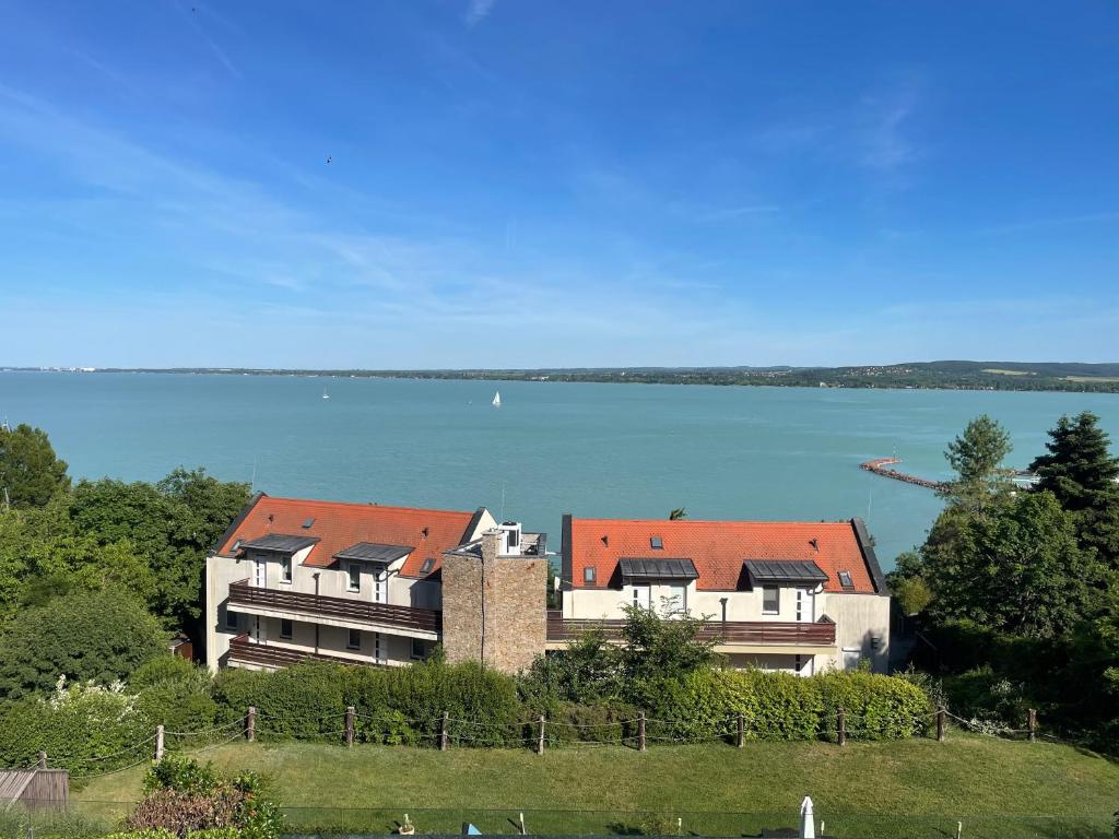 a house on a hill next to a body of water at T8 Sunset Tihany 19 in Tihany