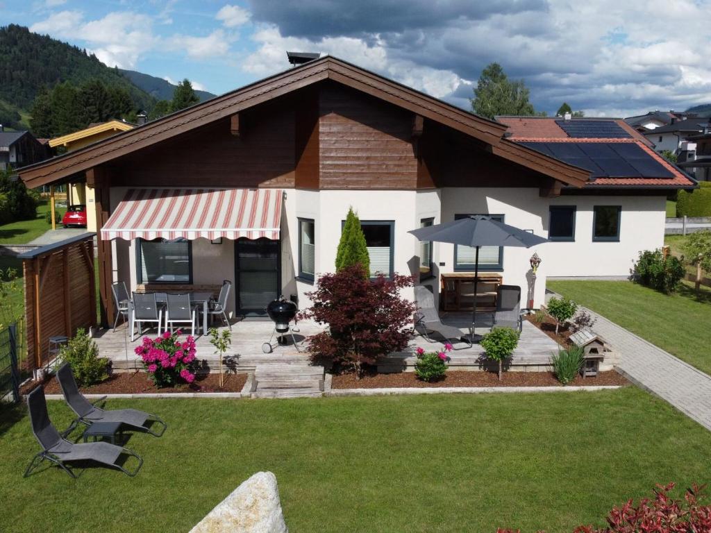 a house with a patio and a lawn at Bruggerheim in Niedernsill