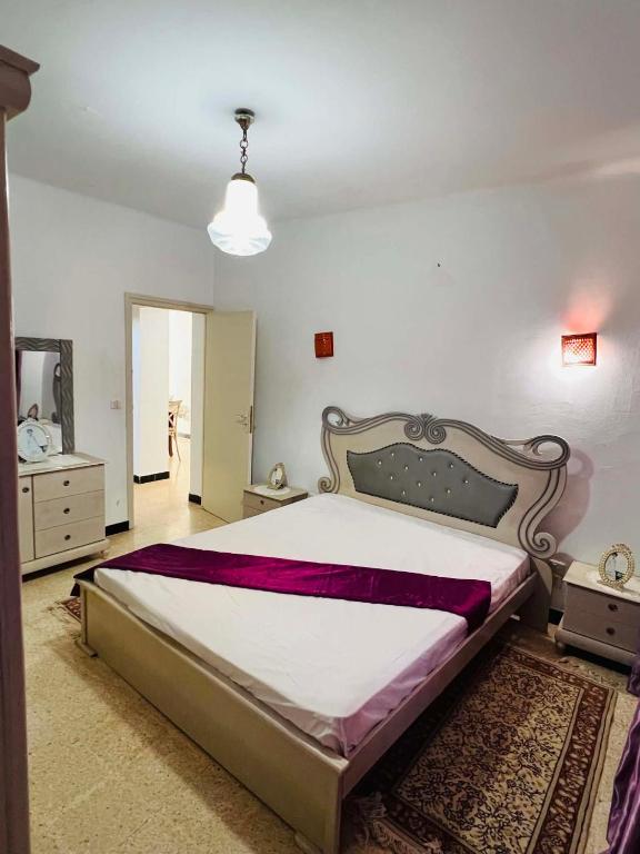 a bedroom with a large bed in a room at maison hajji in Mezraya