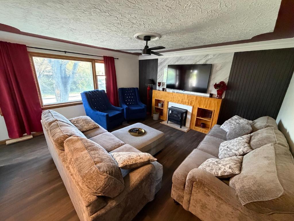 a living room with two couches and a television at Merlot House in Calgary