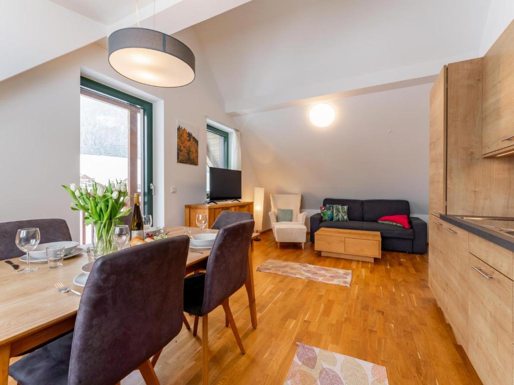 a living room with a dining table and a couch at Passhöhe in Hohentauern