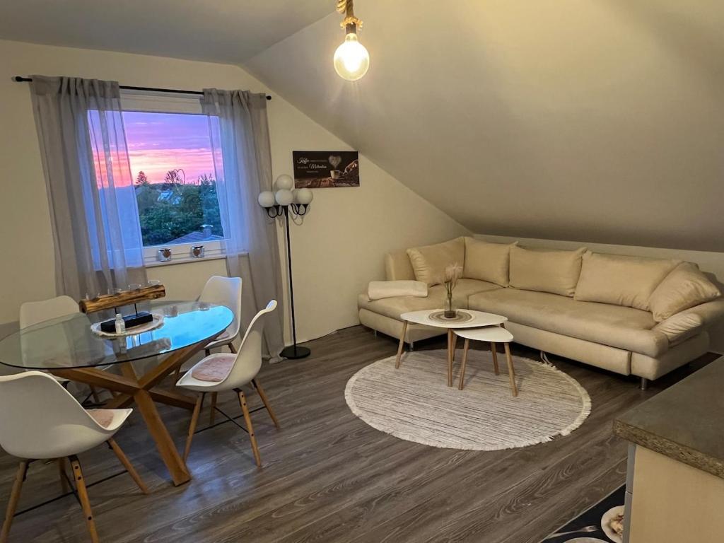 a living room with a couch and a table at Ferienwohnung Emerson in Edemissen