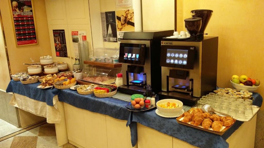 a buffet line with food on a counter in a restaurant at Hotel Ca&#39; Formenta in Venice