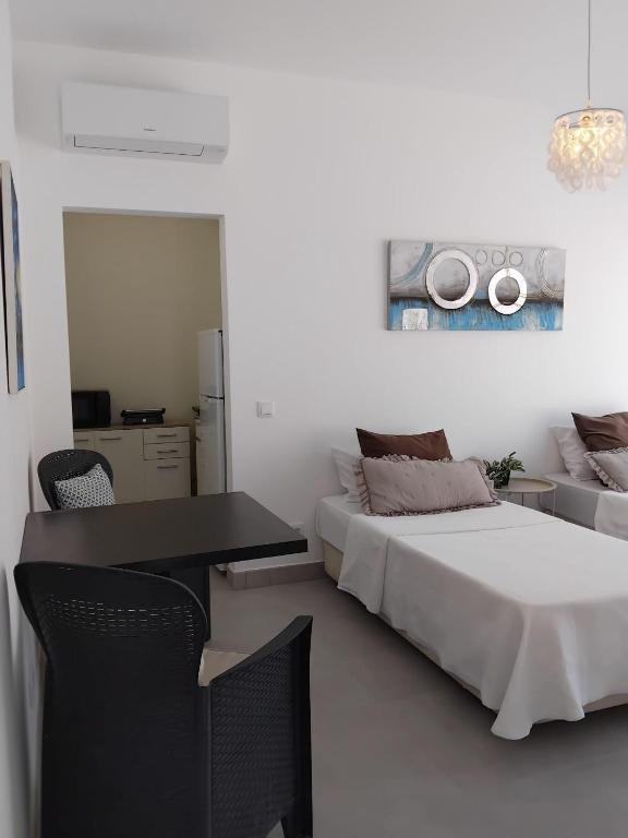 a bedroom with a bed and a desk and a table at Cozy Burgau in Burgau