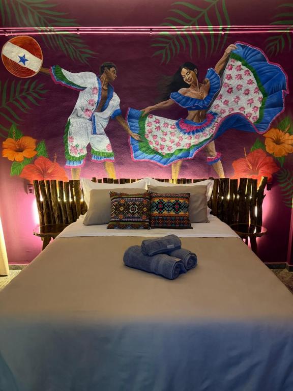 a bedroom with a bed with a painting on the wall at Morada do Boto in Santarém