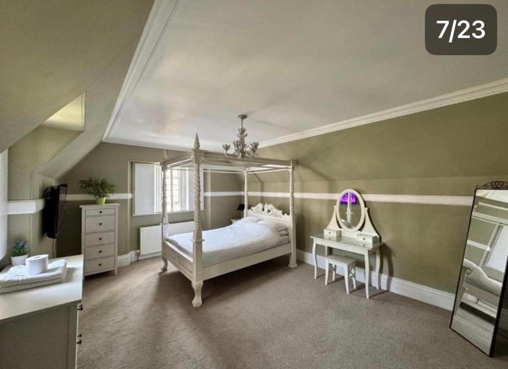 a bedroom with a canopy bed and a mirror at Dundee Beds in Dundee