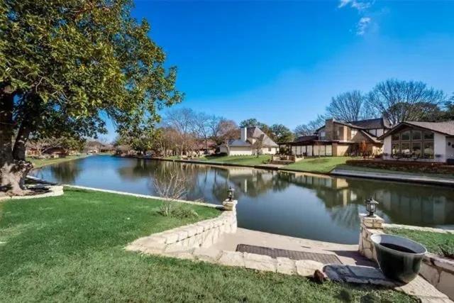 a river in a residential neighborhood with houses at Abundant life in Arlington