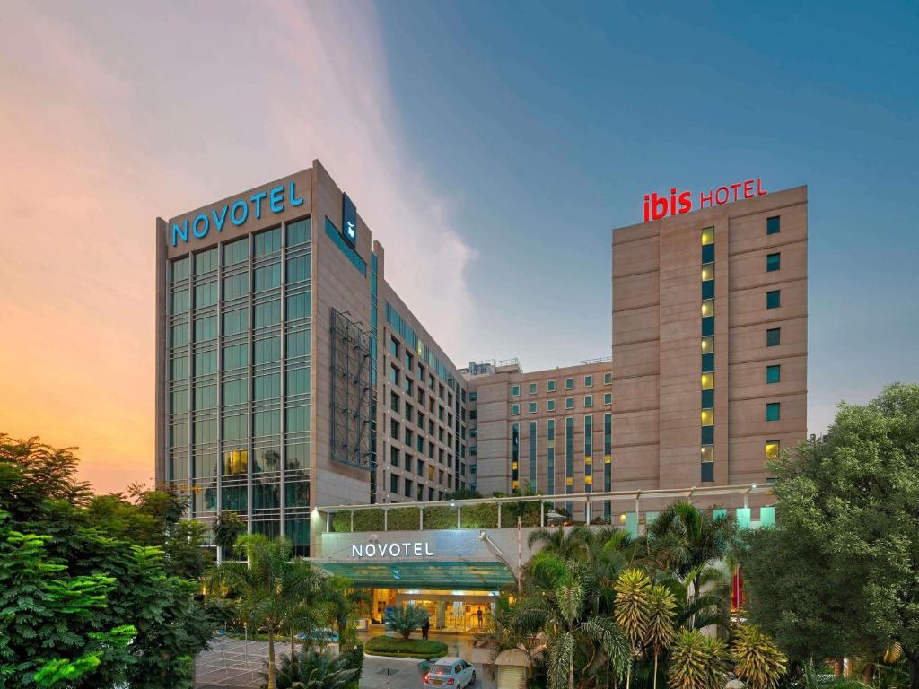 a hotel with a sign on top of a building at Novotel Bengaluru Outer Ring Road in Bangalore