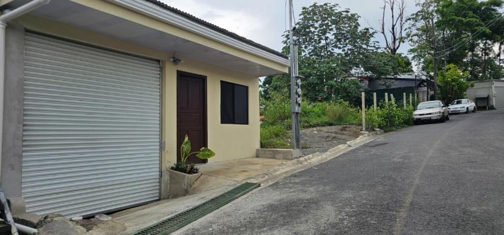 a garage door on the side of a house at Apartment Torres in Manuel Antonio