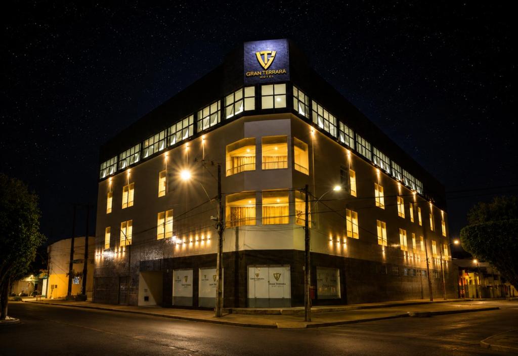 a building with a sign on top of it at night at Granterrara Hotel in Jequié