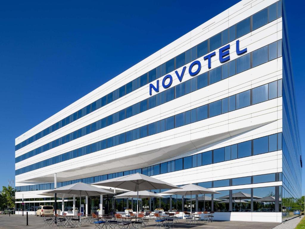an office building with a novotel sign on it at Novotel München Airport in Freising