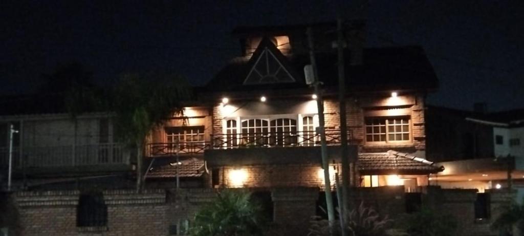 a house with lights on the side of it at night at VICTORIA 3 BED AND BREAKFAST A 3KM DEL AEROPUERTO EZEIZa in Ezeiza