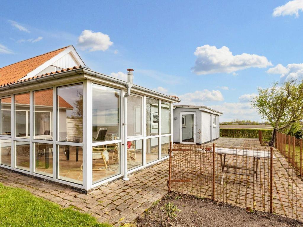 an orangery with sliding glass doors on a house at Lush holiday home in Thyholm in Thyholm